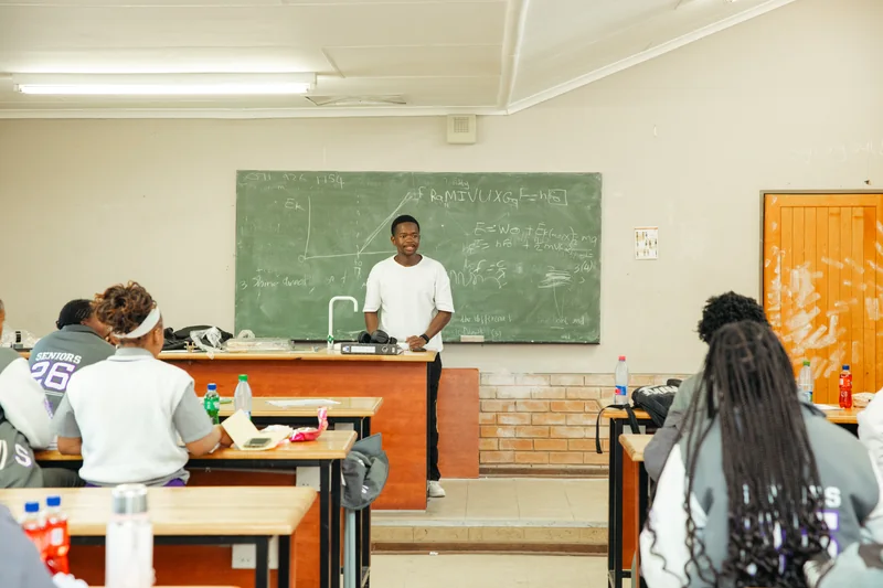 A facilitator teaching a science lesson to learners at Fochville Secondary School.