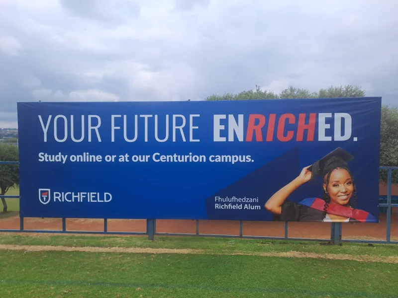 Richfield billboard displaying Your Future Enriched, a study message and a graduate portrait.